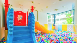 A children's play area with a ball pit and slides.