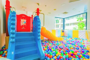 A children's play area with a ball pit and slides.