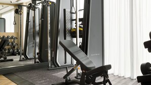 A gym with various exercise equipment, including weight machines and dumbbells. - Voco Southampton (Southampton)