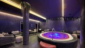 A spa area with a hot tub, seating, and decorative plants. - Verno House Budapest, Vignette Collection, an IHG Hotel (Budapest)