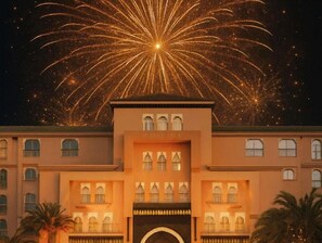 A building with a symmetrical facade, multiple windows, and a central entrance. - Sofitel Marrakech Palais Imperial and Spa (Marrakech)