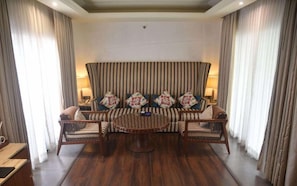 A room with a sofa set, a round table, and curtains. - Taj Alibaug Resort & Spa, Maharashtra (Alibag)