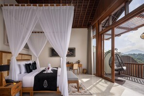 A bedroom with a four-poster bed, a desk, and a view of the outdoors. - The Kayon Valley Resort (Ubud)