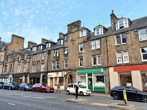 A row of traditional stone buildings with commercial establishments on the ground floor, including a laundrette and a restaurant. - Heart of Inverness home base - all at doorstep (Inverness)