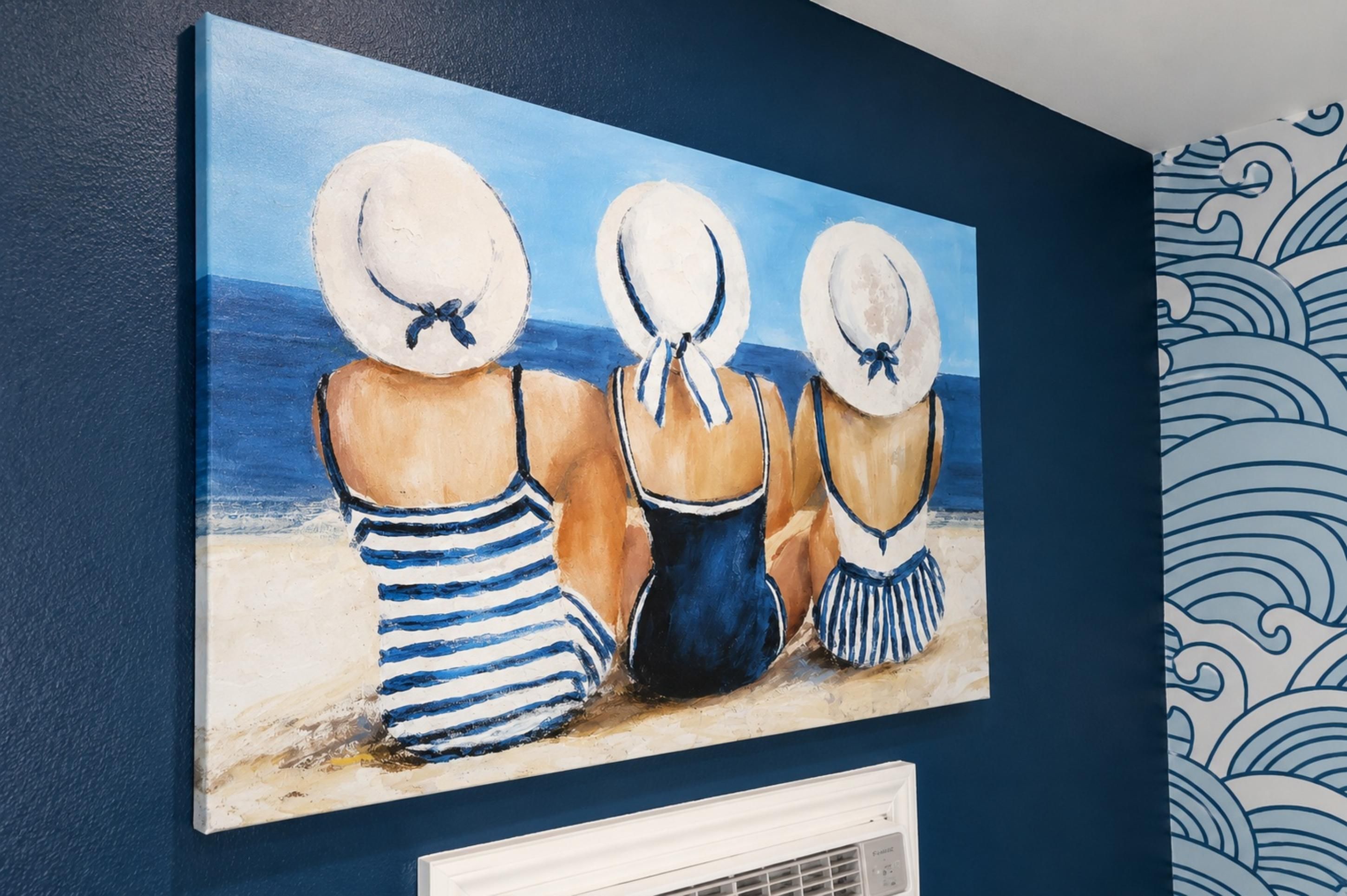 A painting of three figures in beach attire on a wall.
