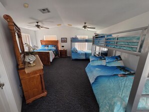 A room with bunk beds, a wooden dresser, a mirror, and ceiling fans. - Parker Strip House Riverfront, Dock, Patio & view!  2-bedroom house with AC/ SPA (Parker)