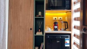 A compact kitchenette with a microwave, coffee maker, and a small refrigerator. - Solé Verde Rooftop Studio I Nesty Hospitality (Al Maadi)