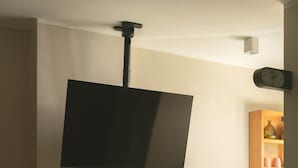 A room with a flat-screen TV mounted on the wall, a desk with a laptop, a chair, and a small kitchenette area with a cabinet and countertop. - Solé Verde Rooftop Studio I Nesty Hospitality (Al Maadi)