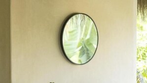 A bathroom with a white sink, a round mirror, and a plant. - Angelique s Boutique Spa & Suites (Troncones)