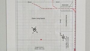 A floor plan with labeled rooms including a legal kitchen, open living space, mechanical room, and bathroom.