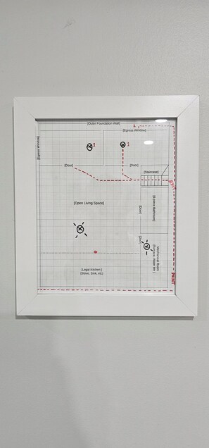 A floor plan with labeled rooms including a legal kitchen, open living space, mechanical room, and bathroom.