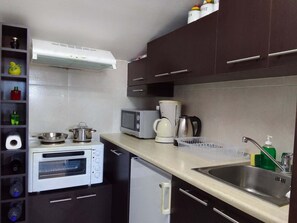 A compact kitchenette with a microwave, toaster oven, coffee maker, and a small sink. - Sofita Di Sofo Kos Vacation Apartment (Kos)