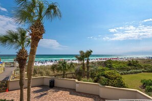 A beach view with palm trees, a sandy beach, and a clear sky. - Beachside 2 4370 Coastal Living decor direct beach access pool (Miramar Beach)