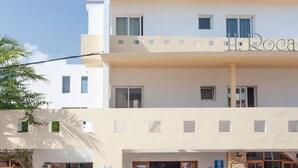 A two-story building with a sign reading 'H. Rocha' on the upper level. - Rocaplana Hostal (Formentera)