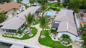 A residential area with modern houses, a swimming pool, and well-maintained gardens. - 18 On the Bay Suite #6 (Indian Rocks Beach)