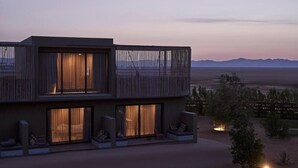 A modern two-story building with large windows and a balcony, set against a mountainous backdrop. - Casa Cook El Gouna (El Gouna)