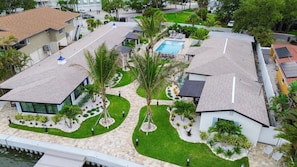 A residential area with modern houses, a swimming pool, and well-maintained gardens. - 18 On the Bay Suite #1 (Indian Rocks Beach)