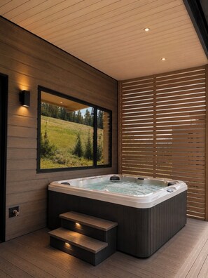 Ein moderner Wellnessbereich mit Whirlpool, Holztreppen und einem großen Fenster mit Blick auf eine grüne Landschaft.