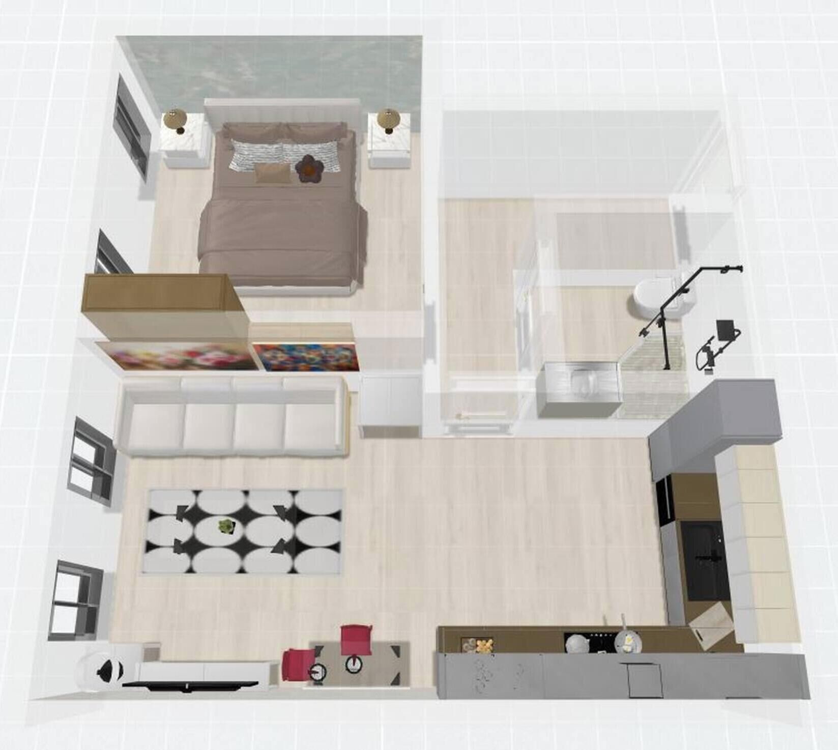 A floor plan of a hotel room with a bed, a sitting area with a sofa and a coffee table, a small kitchen area, and a bathroom.