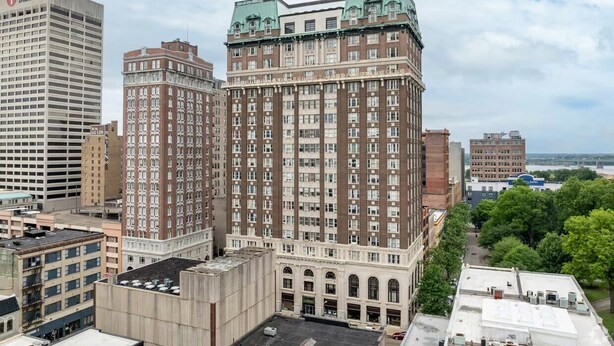 A multi-story building with a prominent bank sign, large windows, and a flat roof.