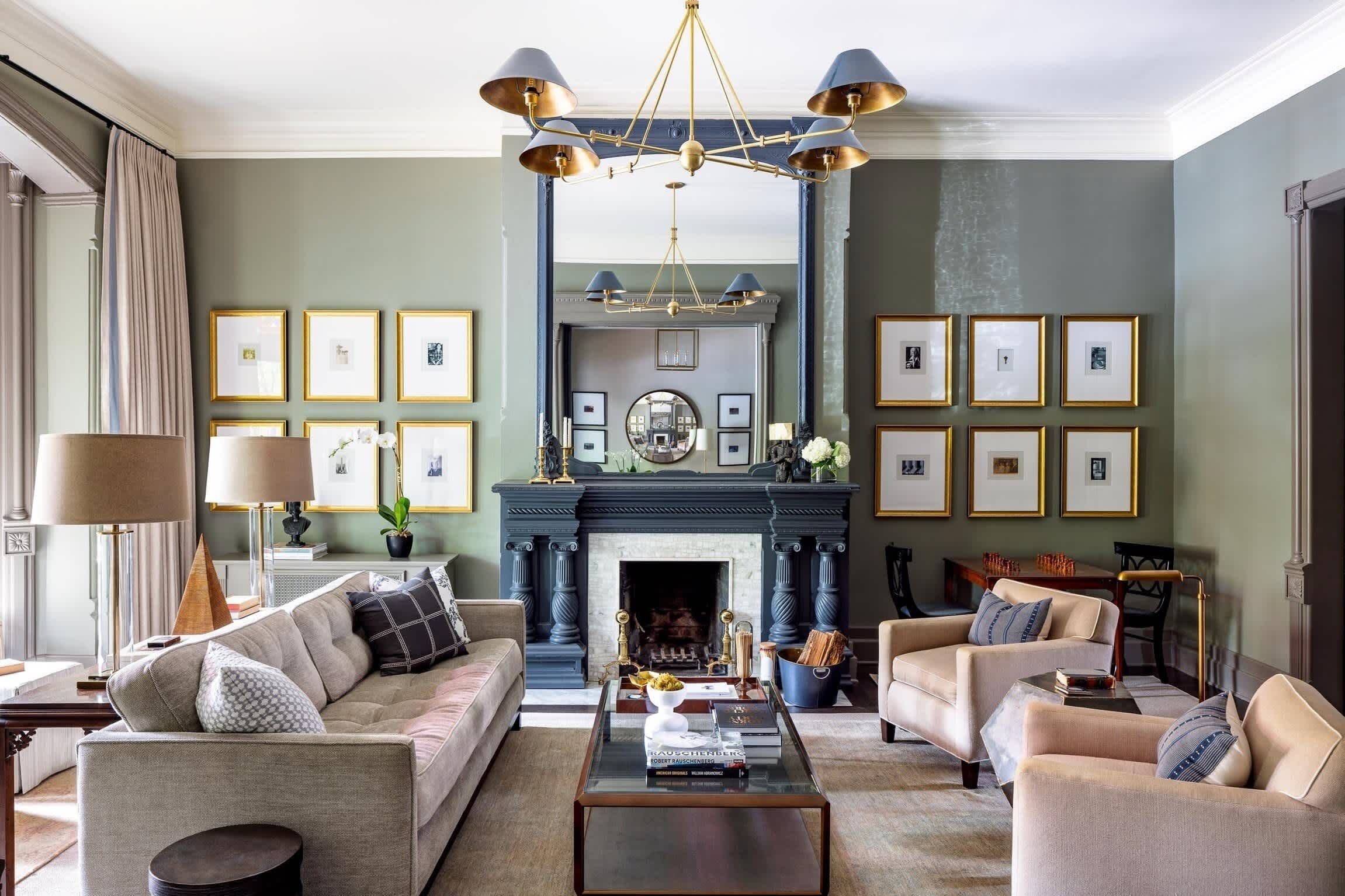 A living room with a fireplace, sofas, a coffee table, and framed pictures on the walls.