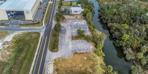 An aerial view of a parking lot adjacent to a building with a large, flat roof. - Waterfront Suite with Jacuzzi Tub & Fireplace (Hernando beach)