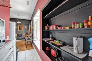 A modern kitchen with a black countertop, a red toaster, and various kitchen appliances. - HUGE Eclectic Downtown Memphis 1 bedroom with LOUNGE area AND living room (Memphis)