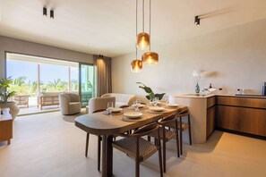 A modern dining area with a wooden table set for six, surrounded by chairs. - Private Pool Escape - Luminara at The Reef (Willemstad)