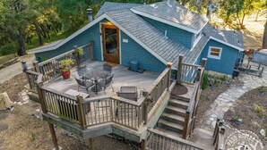 A two-story house with a deck, a staircase, and a door leading to the interior. - Dunning Ranch Guest Buyout by Avantstay 40-acre Vineyard Estate + Spa Tub BBQ + Private Decks (Paso Robles)