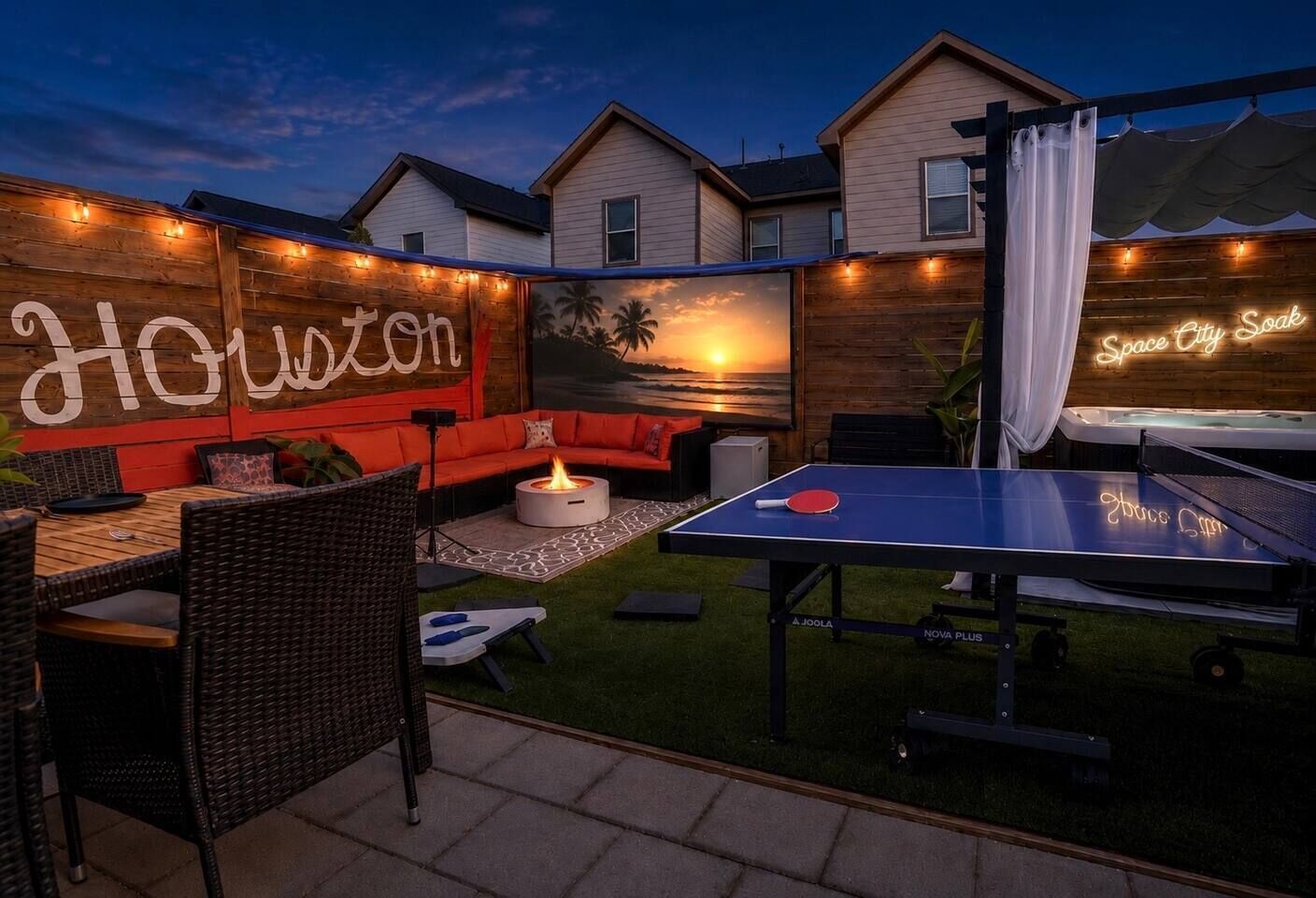 Une terrasse extérieure équipée d’une table de ping-pong, d’un canapé et d’un foyer.
