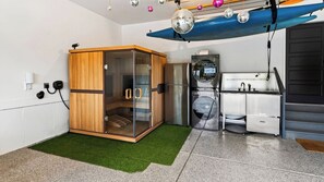 A compact kitchen with a built-in refrigerator, a microwave, and a sink.
