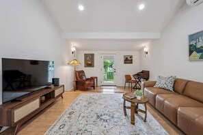 A living room with a TV, sofa, coffee table, and a rug. - Heart of Sonoma Wine Country, Kenwood (Kenwood)