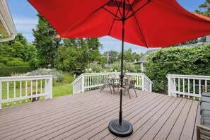 A wooden deck with a red umbrella, white railings, and a table with chairs. - Heart of Sonoma Wine Country, Kenwood (Kenwood)