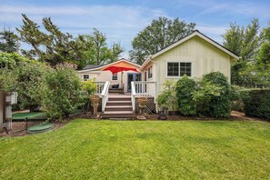 A two-story house with a front porch, a red umbrella, and a well-maintained lawn. - Heart of Sonoma Wine Country, Kenwood (Kenwood)
