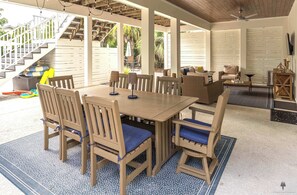 An outdoor covered patio with a wooden table and chairs, a ceiling fan, and a view of the outside. - Blue Mountain View | Private Pool, Rooftop Deck & Bikes (Santa Rosa Beach)