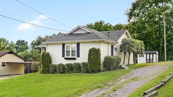 A single-story house with a sloped roof, a front porch, and a small attached garage.