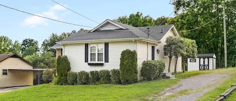 A single-story house with a sloped roof, a front porch, and a small attached garage.
