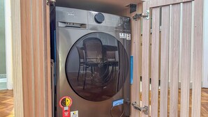 Máquina de lavar compacta e moderna, com painel de controle, visor digital e abertura frontal.