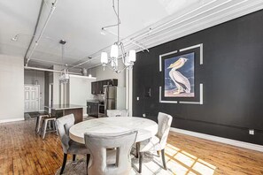A modern dining area with a marble table, cushioned chairs, and pendant lighting. - Casual corner (Detroit)
