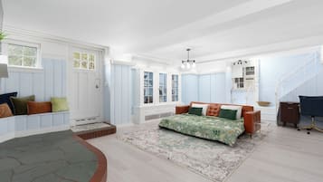 A spacious bedroom with a large bed, a built-in wardrobe, and a staircase leading to an upper level.