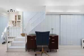 A modern office space with a desk, chair, and staircase. - The Secret Garden at Benefit~

Tranquil, starlit views in PVD with Parking! (Providence)