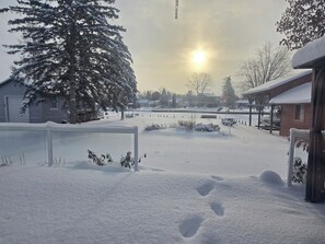 A snowy residential area with a house, a tree, and a clear sky. - Waterfront 3 bdrm+  house in Lagoon City, Brechin, 70 minutes north from Toronto (Brechin)
