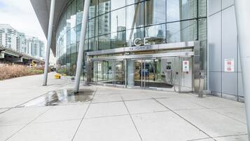 A modern building with a glass facade, a prominent entrance with a revolving door, and a sign indicating '12 York St.'