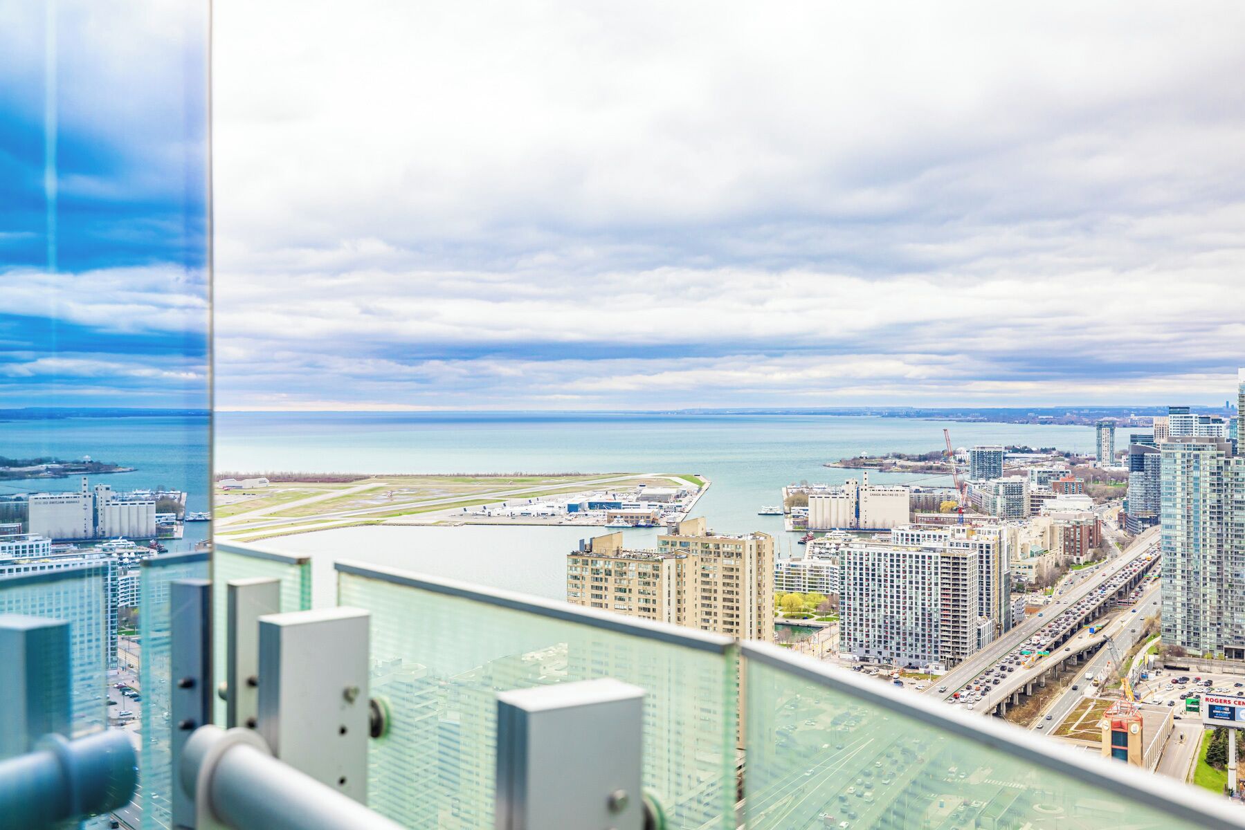 A high-rise building with a view of a cityscape and a body of water.