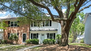 A two-story house with a large tree in front. - Lowcountry Retreat | Minutes to Everything! (Mt Pleasant)