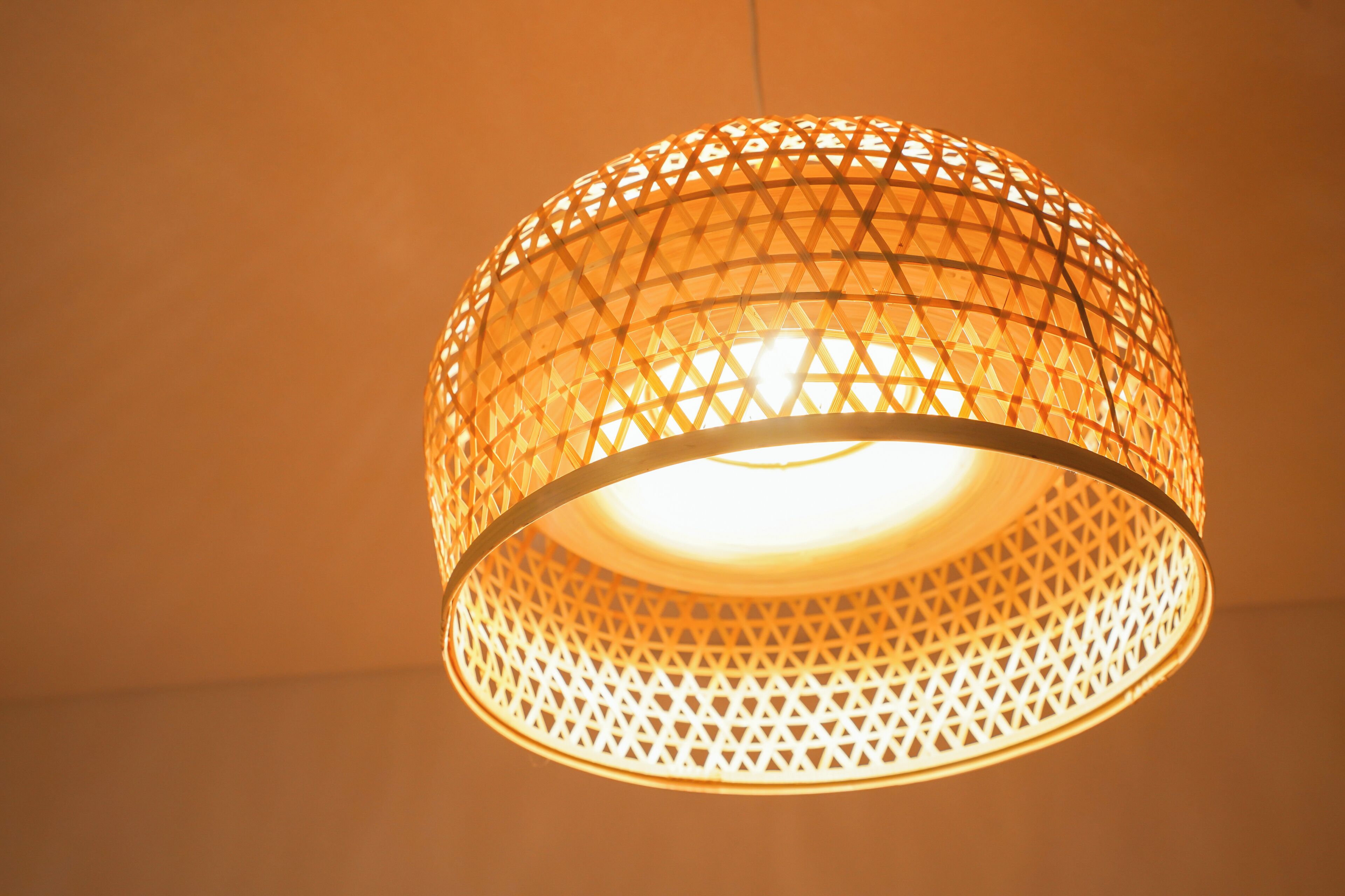 A hanging light fixture with a geometric pattern.