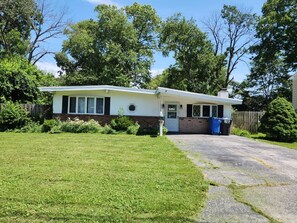 A single-story house with a front porch, a garage, and a well-maintained lawn.
