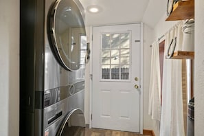 A hallway with a white door, a large mirror, and a built-in oven. - Keep Tahoe Cozy - Pet friendly, walk to Lake & Ski (South Lake Tahoe)