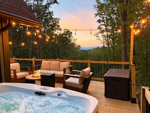 A deck with outdoor seating, a hot tub, and string lights. - NEW Secluded Retreat Mountain Views, Hot Tub, River access (Shenandoah)