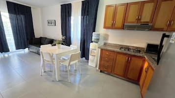Suite Deluxe, balcón, vistas al jardín | Cocina privada | Cafetera o tetera, frigorífico grande, placa de cocina y tostadora